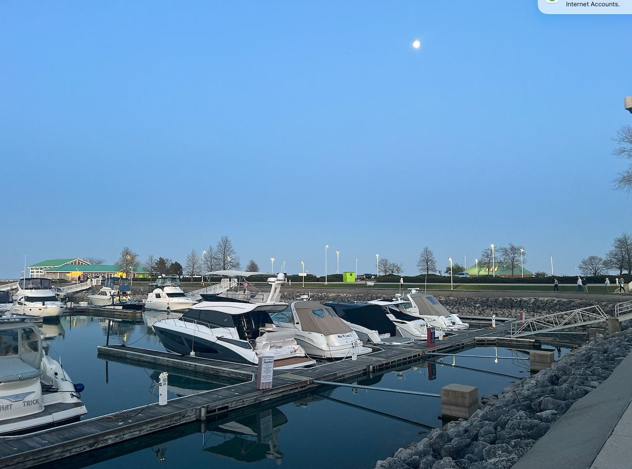 Boats docked at North Point Marina at dusk with calm water reflections